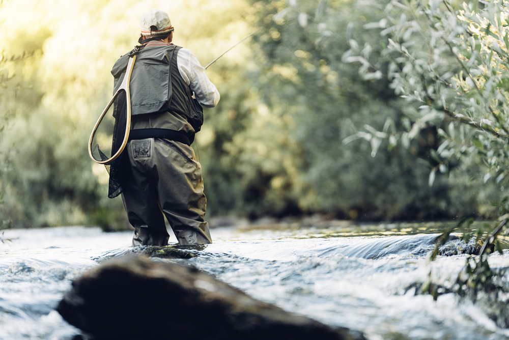 man fly fishing in a stream