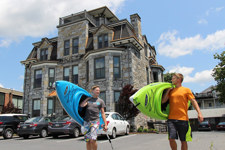 Picture of two men carrying kayaks